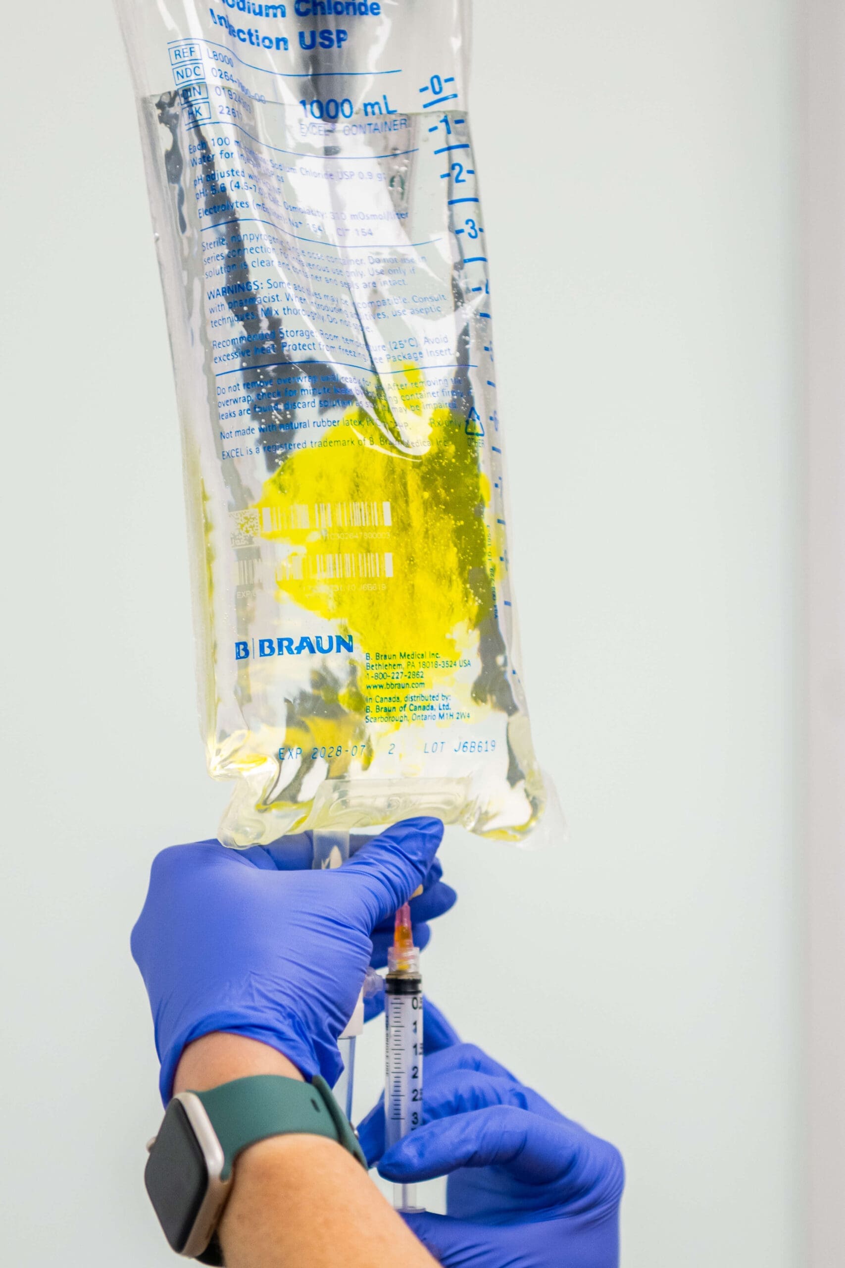 Details of an IV treatment bag being supplemented by an injection