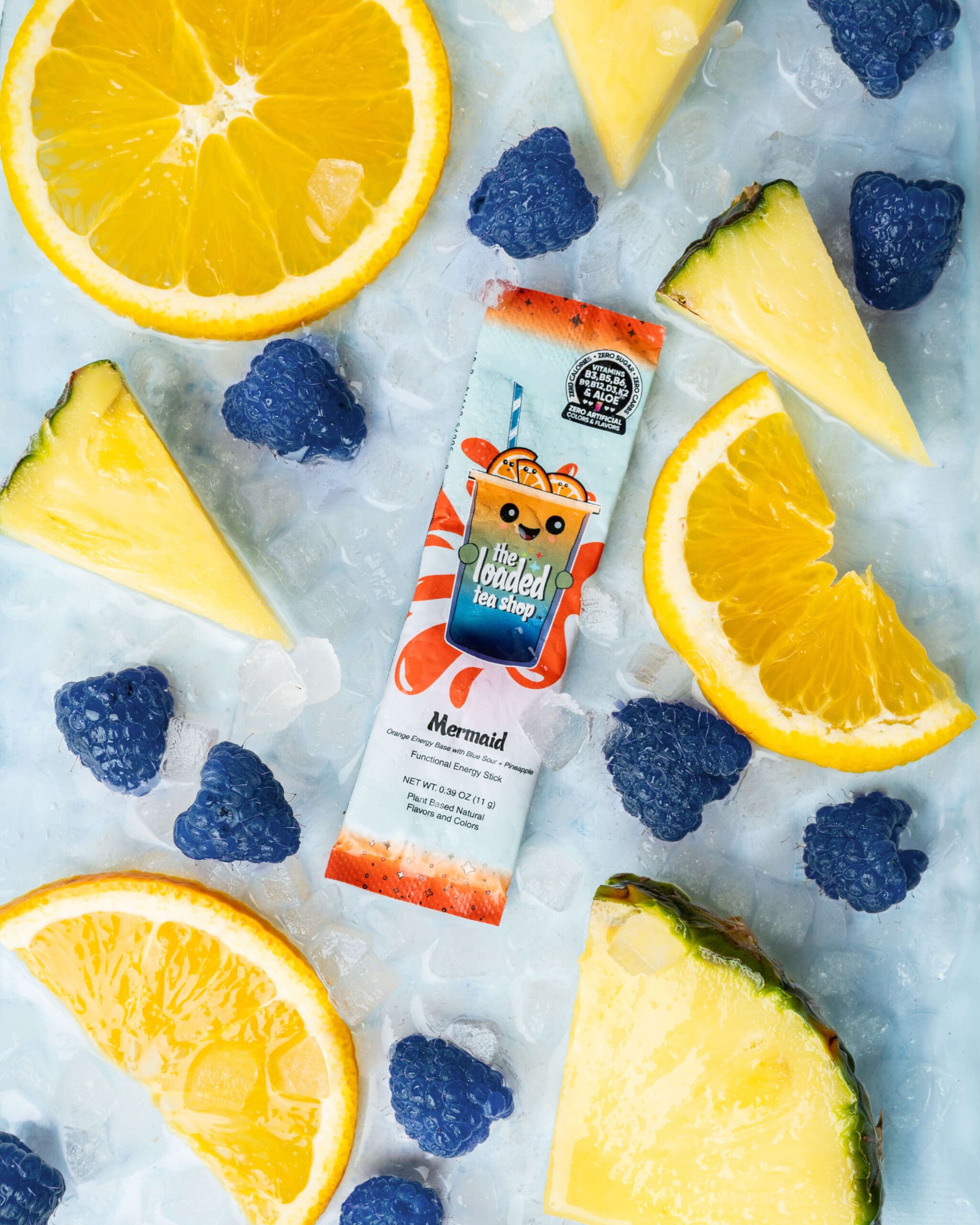 Details of a drink powder packet on a bed of ice surrounded by fruit